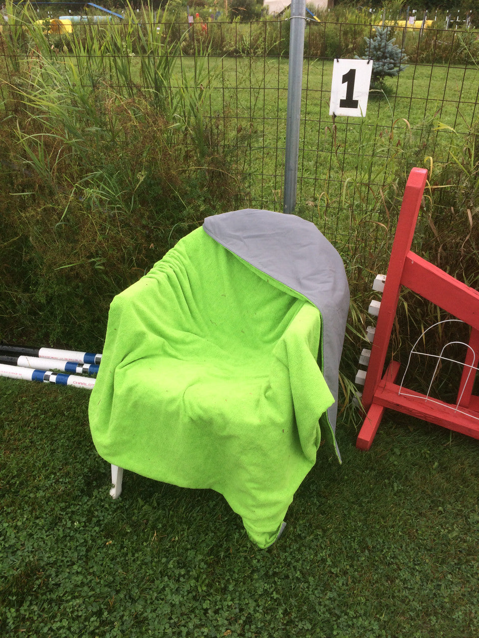 Chilly Dogs Soaker Blanket over a wet chair at an agility trial.