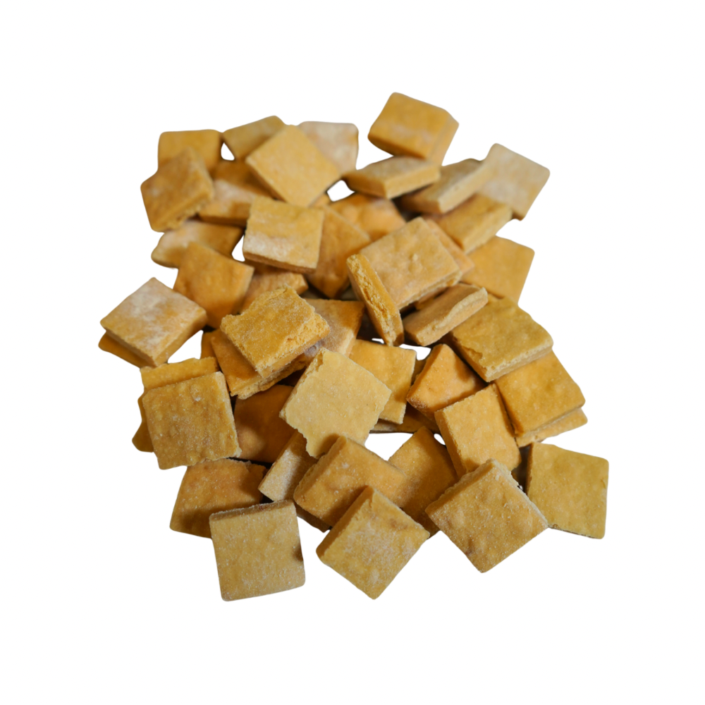 Only One wild Pacific salmon training treats, small square-shaped, light yellow biscuits piled together.