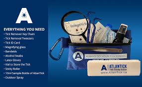 PureGard tick kit with tools including tweezers, ID card, band-aids, and outdoor spray in a blue pouch.